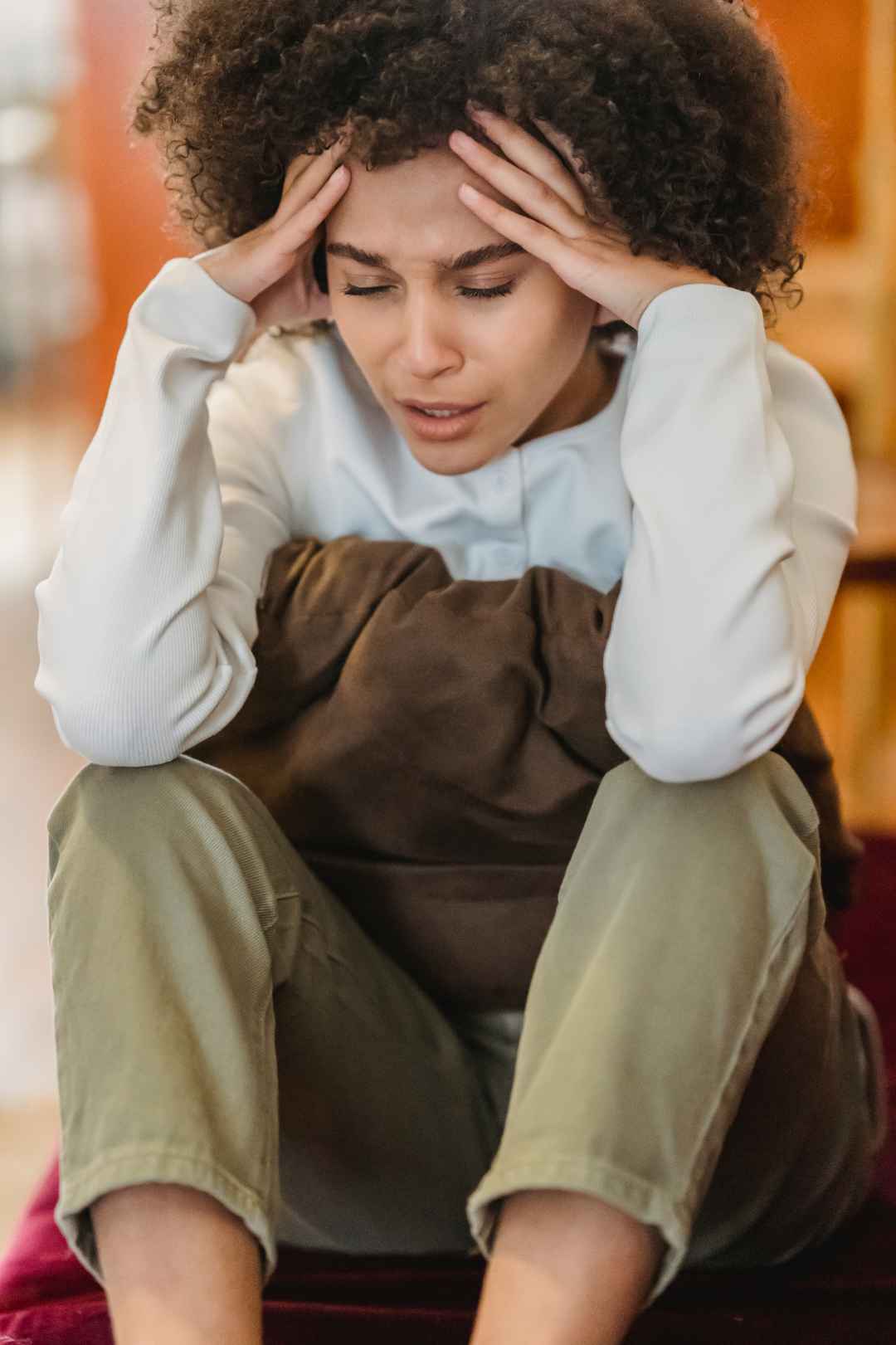 Black woman with hands on her end experiencing the impact of anxiety