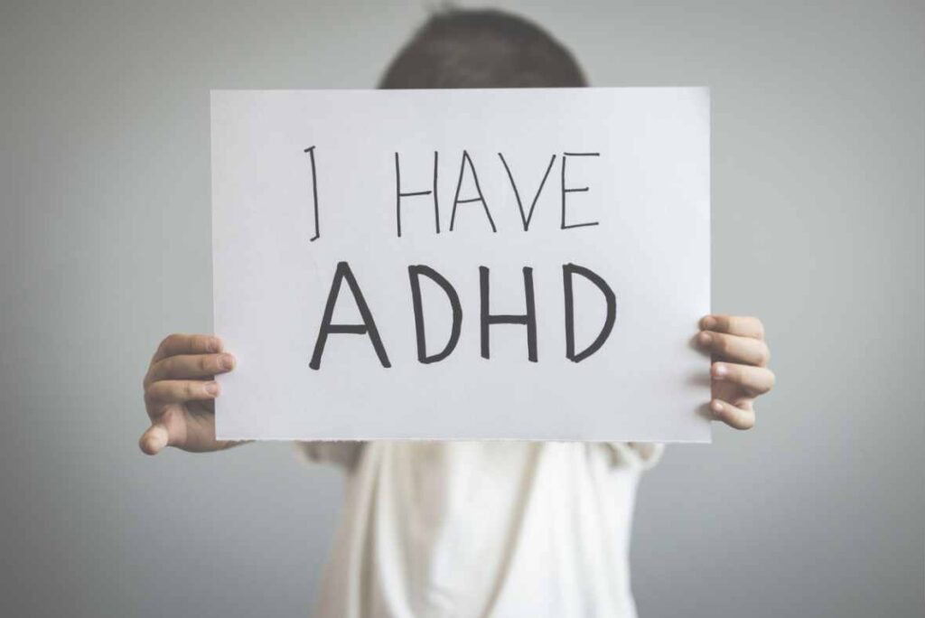 I have ADHD - child holding up a sign that says I have ADHD