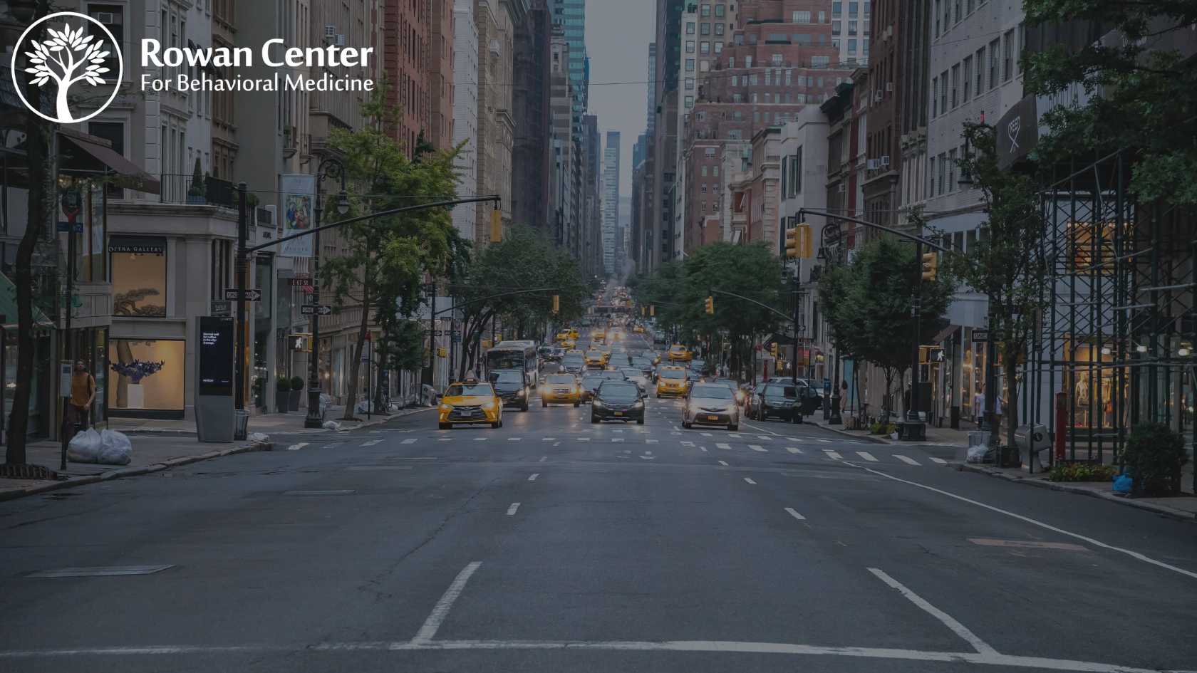 Rowan Center for Behavioral Medicine New York Location showing Rowan logo in corner with New York City street, cars and buildings in the background