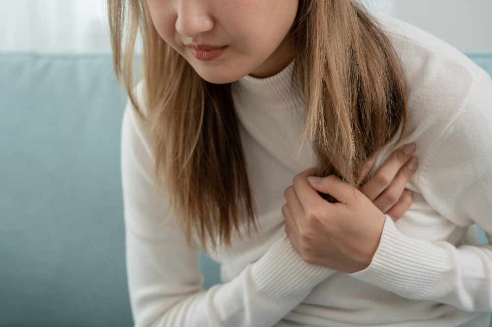 Woman holding her heart impacted by anxiety